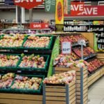 Bevásárló pénztár egy magyar szupermarketben, ahol a csökkenő élelmiszerárak jelképezik a kedvezőbb vásárlási lehetőségeket.